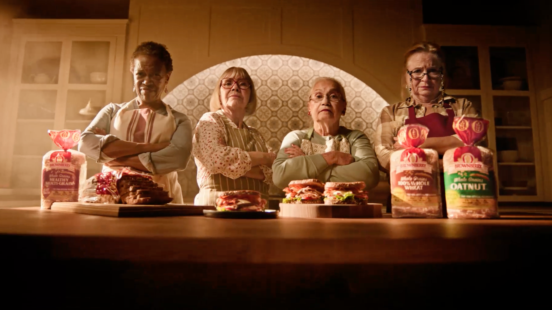 Four women in kitchen with Brownberry bread and sandwiches